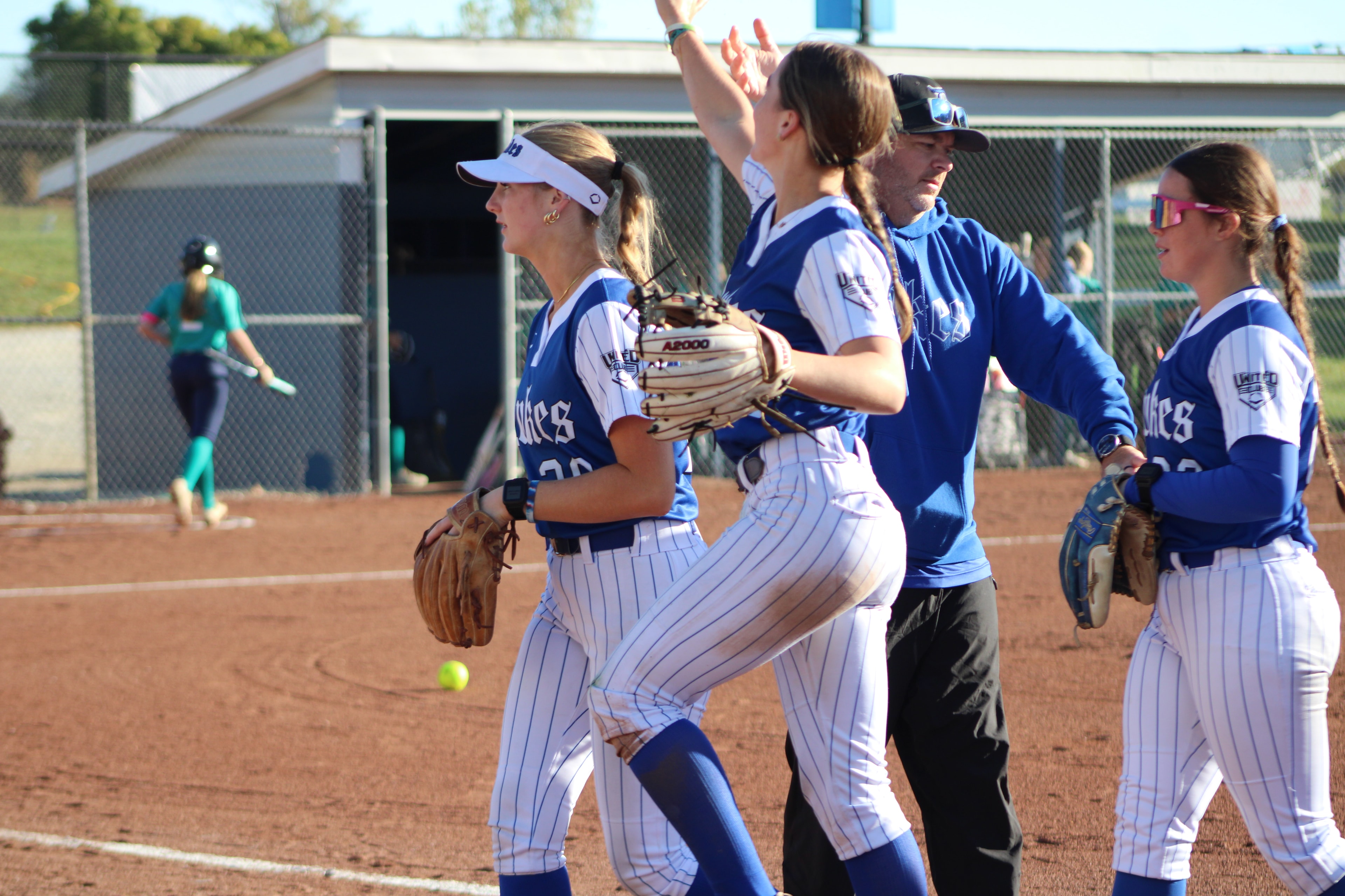 Lady Dukes players on the field during game action