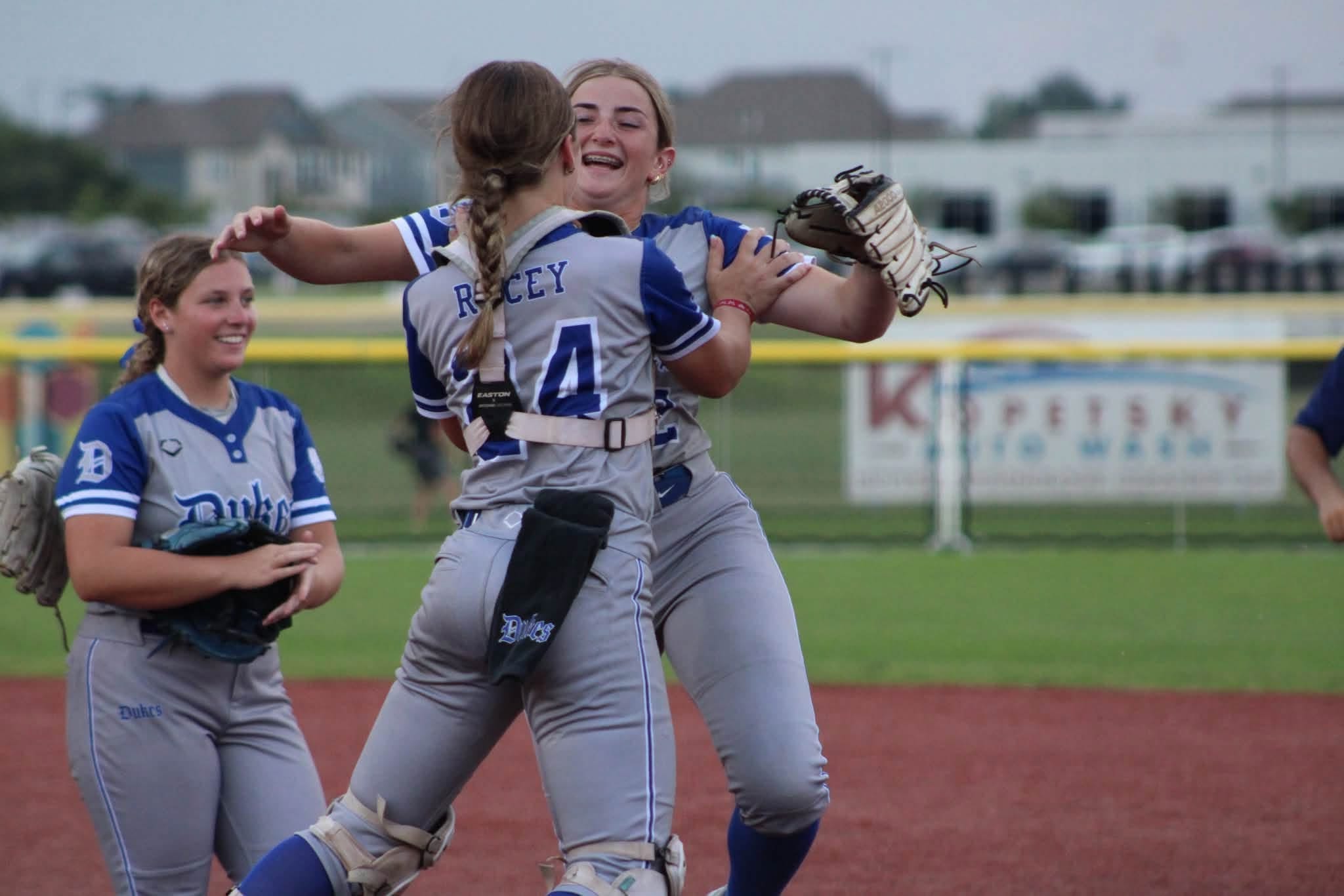 Lady Dukes players celebrating after a big play