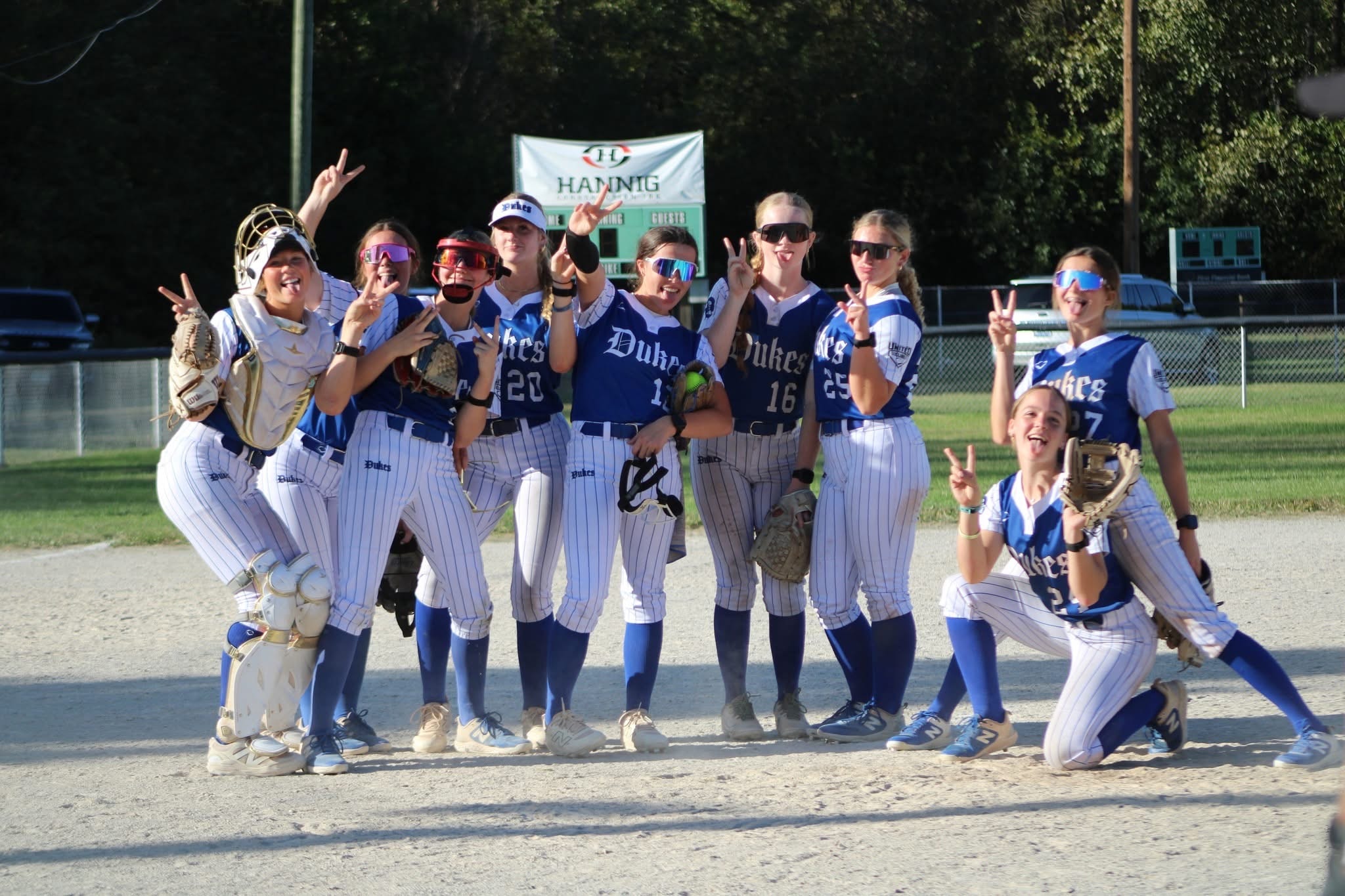 Lady Dukes team celebrating on the field