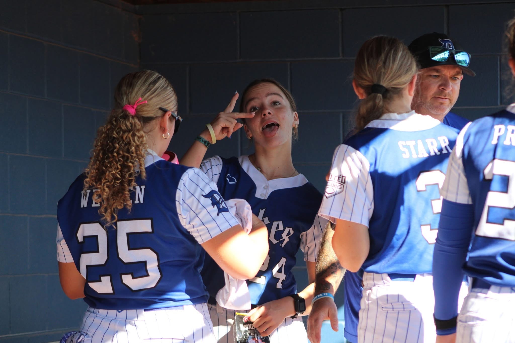 Lady Dukes players in the dugout